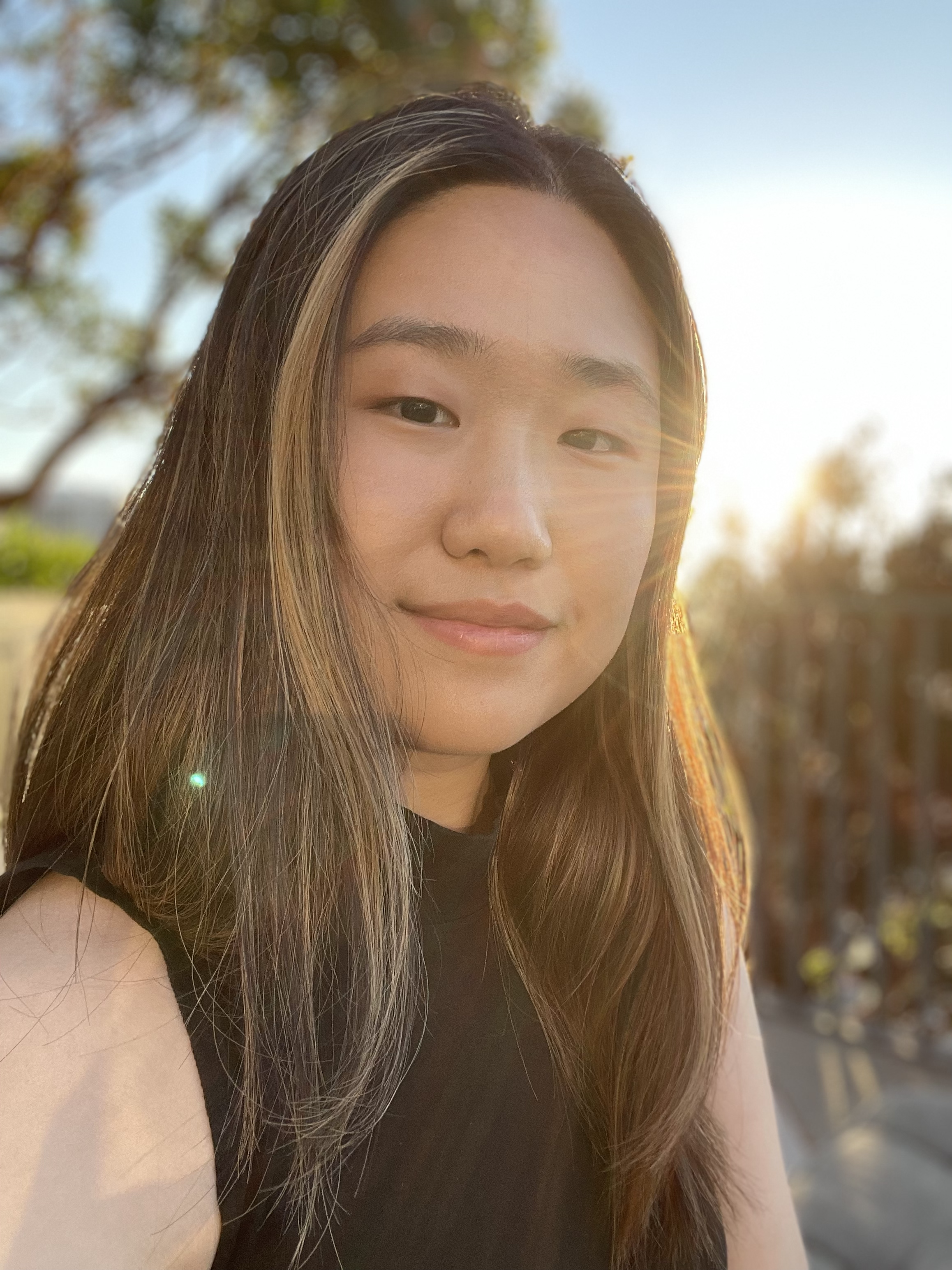 Sophie Wang standing next to a disco ball in a modern art exhibit